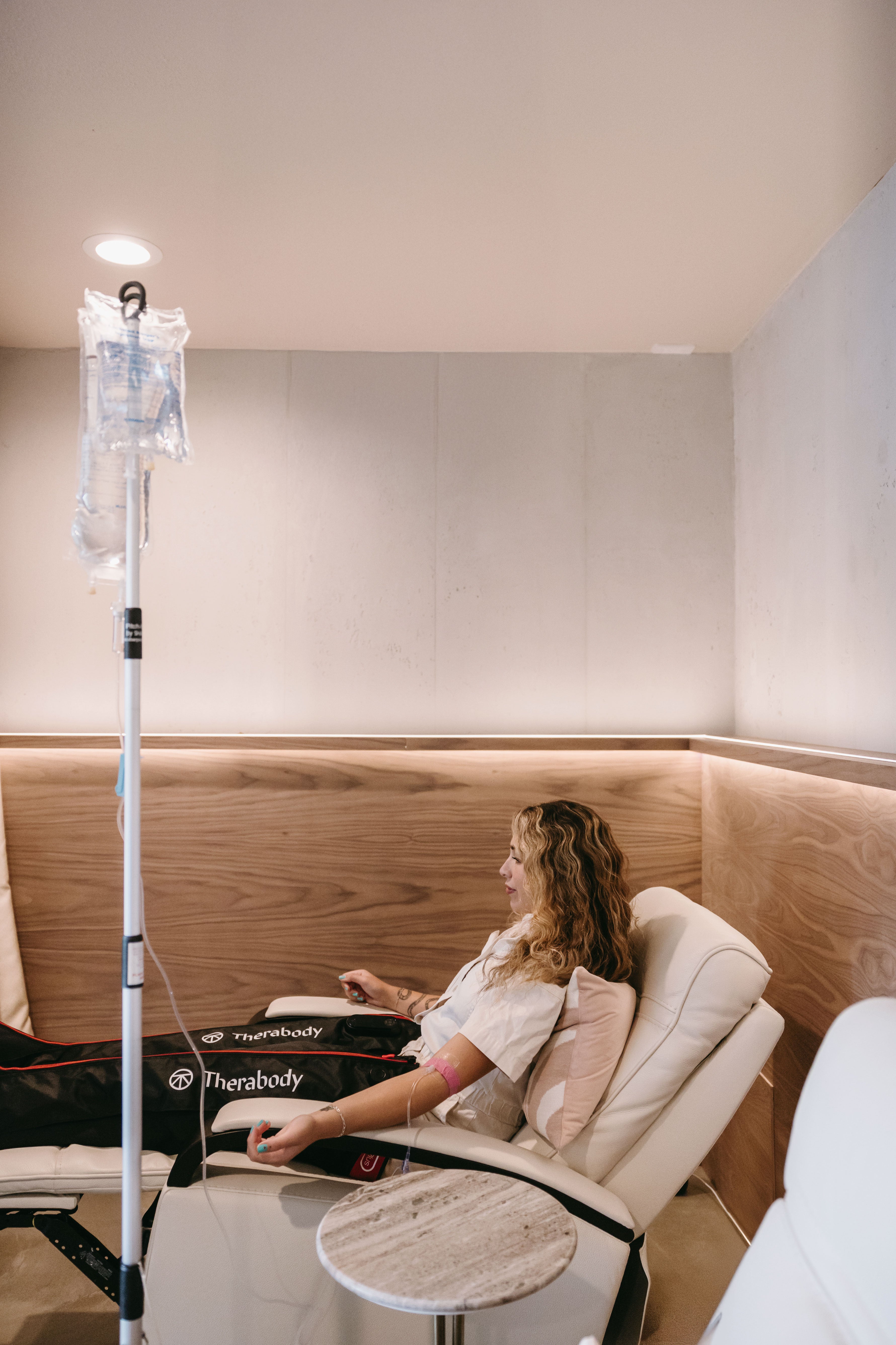 Woman receiving intravenous therapy in a clinical setting